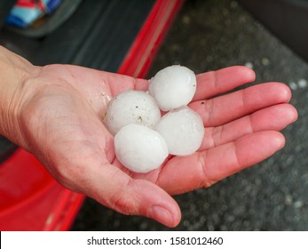 Four large pieces of hail in the hand