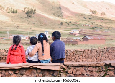 Four Latin Kids Sitting On The Wall And Admiring A Beauty Of The Nature.