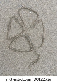 Four Leaf Clover Drawn In The Sand Beach