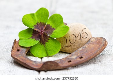 four leaf clover, horseshoe with stone and writing on wood, 2015 - Shutterstock ID 237752830
