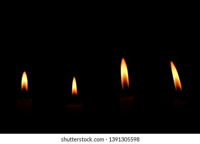 Four Light Flame Candle Burning Brightly On Black Background