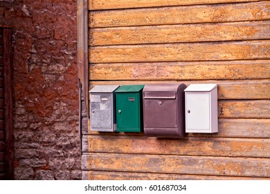 Four mail boxes in a row on an old building in Tallinn, Estonia. Looks like the building has seen better days.