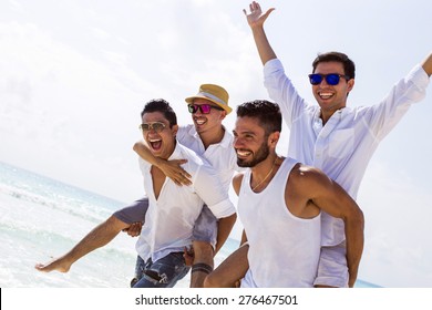 Four male friends at the beach - Powered by Shutterstock