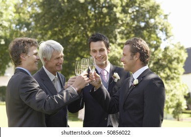Four men toasting at wedding