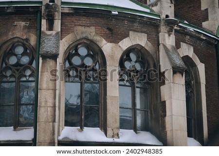 Four old pointed gothic windows with stained glass on facade of the building. Baroque and Gothic architecture. Church of St. Olga and Elizabeth. Lviv, Ukraine. Stock photo © 