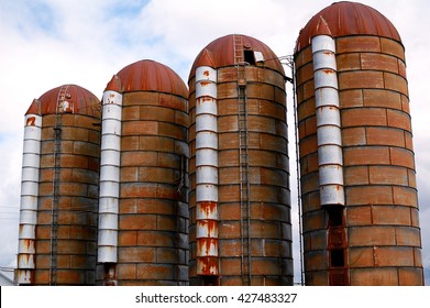 Four Old Rusty Grain Silos