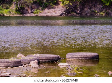 Four Old Tires Lineup Next To Each Other To Form A Foot Bridge At The Bank Of A River In South Korea