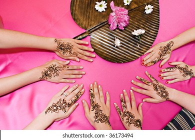 Four pairs of hands with traditional henna deisgns