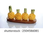 Four Peeled Pinapple Nanas Madu Pemalang on Wooden Plate, Isolated on White 