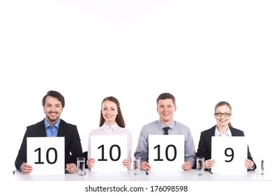 four people sitting at table and smiling. handsome and pretty girls and man showing numbers - Powered by Shutterstock