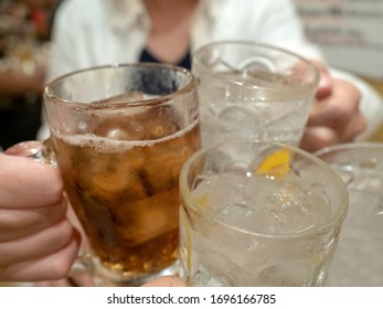 Four People Toasting With Glasses Of Oolong High And Lemon Chu High

