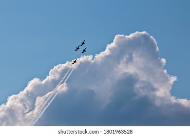 Four planes on the background of clouds. Aerobatics