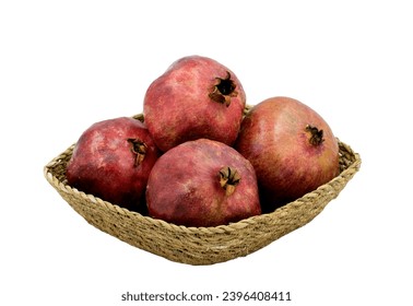 Four pomes of the pomegranate (Punica granatum) in a basket plate