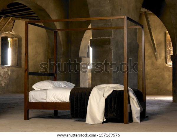 Four poster bed\
inside old historic\
building