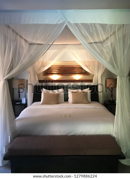 Four poster bed\
at a luxurious Balinese\
villa