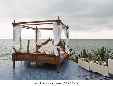 Four Poster Bed On Patio By The Sea