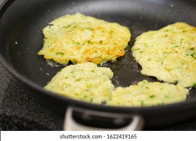 Four Potato Pancakes Cooking In Oil During Holiday Food Preparation