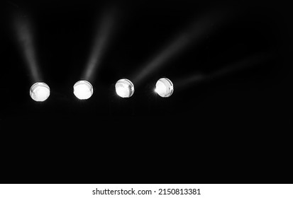 four powerful stage spotlight on the black background without people ideal as a concert backdrop