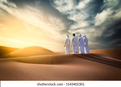 Four Proud Arab Young Man Standing On The Dune In Desert Celebrating  Spirit Of The Union - UAE National Day 