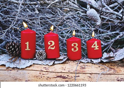 Four Red Advent Candles With Number As Catholic Symbol Of Christmas. Christmas Decoration With Burning Candles For Advent Time