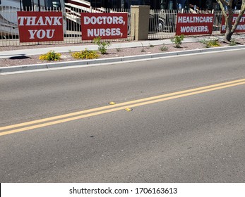 Four Red Banners On A Fence Stating Thank You Doctors, Nurses, Healthcare Workers, First Responders In Support Of Those Fighting The Novel Coronavirus Covid19 In The USA