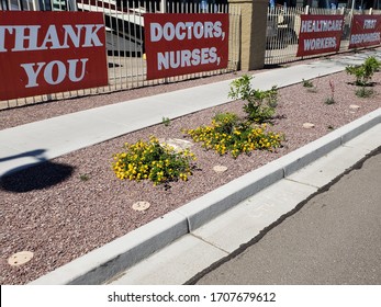 Four Red Banners On A Fence Stating Thank You Doctors, Nurses, Healthcare Workers, First Responders In Support Of Those Americans Fighting The Novel Coronavirus Covid19