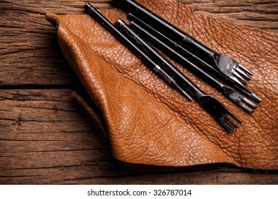 Four Size Leather Craft Tools. Hole, Punches, Lacing, Stitching. DIY Metal Steel for Leather Crafting, Handcrafts Work, Handmade with Leather Workspace. Concept and Idea of Leather Business Industry. - Shutterstock ID 326787014