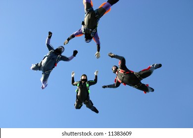 Four skydivers building a star formation