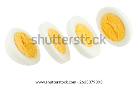 Four slices of boiled eggs falling against a transparent background, ideal for food and nutrition related projects