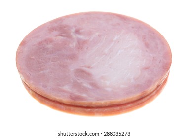 Four Slices Of Honey Ham Deli Meat In A Stack On A White Background.