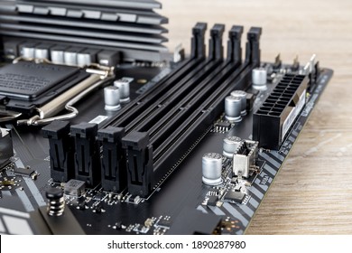 Four Slots For Ddr4 Ram Memory Modules On A Modern Black Pc Motherboard. Computer Mainboard Circuit Components. Desktop Hardware Close-up.  PC Components For Assembly, Upgrade And Repair. Front View.