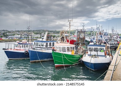 Four Small Fishing Boats Moored In Howth Harbour. Phishing And Shellfish Fishing Equipment On Fishing Boats, Dublin, Ireland