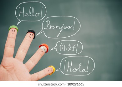 Four smiley fingers on a blackboard saying hello in English, French, Chinese and Spanish. 