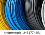 Four Spools of Electrical Wire in Yellow, Blue, Black, and White Colors: A Close-Up Photo of Four Spools of Electrical Wire, Each Wound in a Different Color.