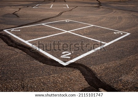Four Square game painted on asphalt surface in school playground