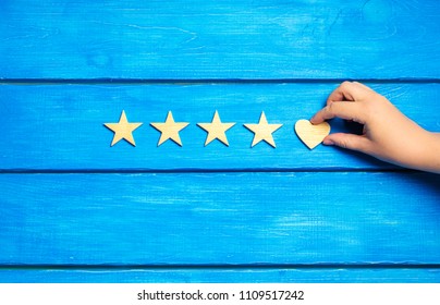 four stars and heart on a blue background. rating five stars, the choice of the editorial office and the buyer. concept of rating, review. quality, service