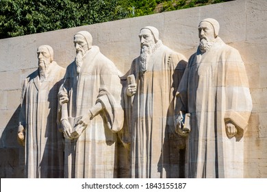 The four statues at the center of the Reformation Wall in the Parc des Bastions in Geneva, Switzerland, representing John Calvin and the Calvinism's main proponents, on a sunny summer day.
