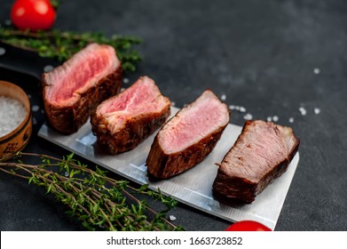 
Four Steaks On
Knife On A Stone Background. Four Types Of Meat Frying Rare, Medium, Medium Good, Well Done