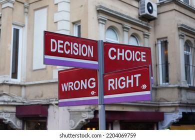 Four Street Signs,  Sign Post,  Sign The Post With Four Signs In Front Of Shops On The Street, Iron, Metal Intersection Sign With Four Arrows. 