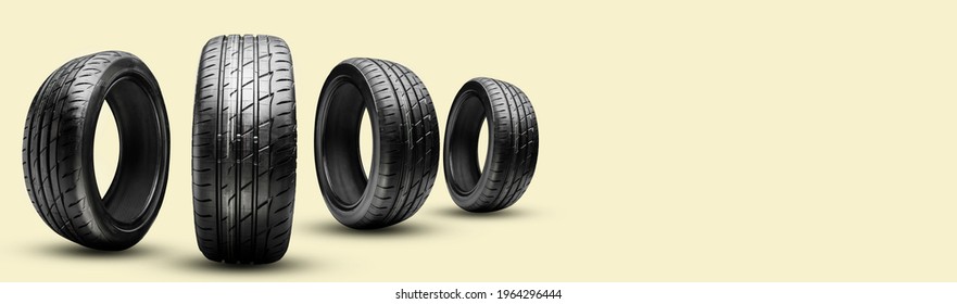 four summer tires on a yellow background, long panoramic copy space concept