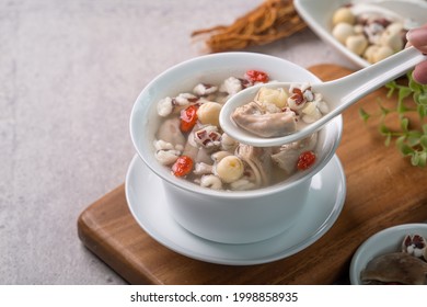 Four Tonics Soup. Close up of delicious homemade Taiwanese traditional Chinese herb flavor food with herbs, pork intestine on gray table background - Shutterstock ID 1998858935