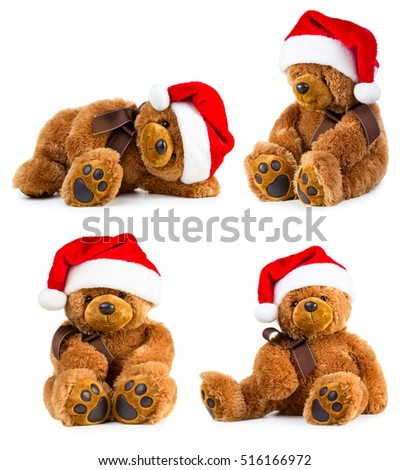 Four toy teddy bear wearing a santa hat isolated on white background
