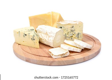 Four types of cheese on a round wooden board isolated on white background. Ripe parmesan, goat cheese with white mold, roquefort and dorblu.