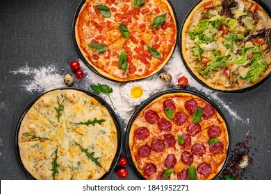 Four Types Of Pizza Shot From Above On Wooden Boards