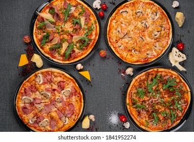 Four Types Of Pizza Shot From Above On Wooden Boards