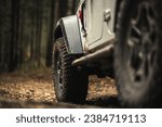 Four Wheel Drive AWD Vehicle on the Muddy Forest Road Close Up