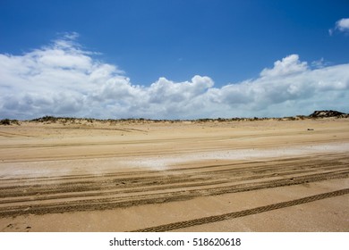 Four Wheel Drive Tracks In Sandy Cable Beach, Broome Western Australia,  A 22 Kilometre Long Stretch Of White Sand, Set Against Red Ochre Cliffs And Fringed By Turquoise Waters Of The Indian Ocean.