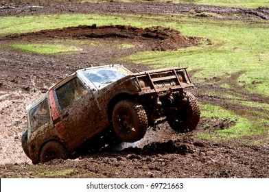 Four Wheel Drive Vehicle Bouncing It's Way Out Of A Hole