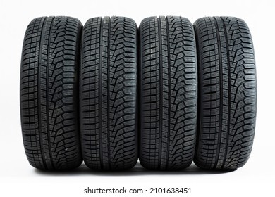 Four wheels with winter tires from front view isolated on white background.