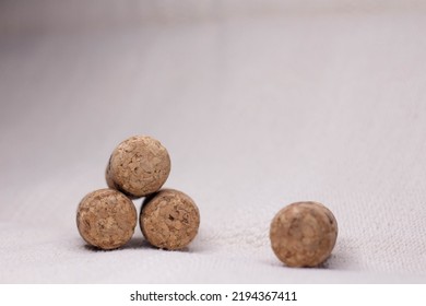 Four Wine Corks With A Pyramid On A Light Background